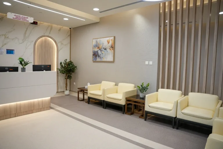 Reception at the alkalma Al Falah clinic with an arched marble feature wall and seating